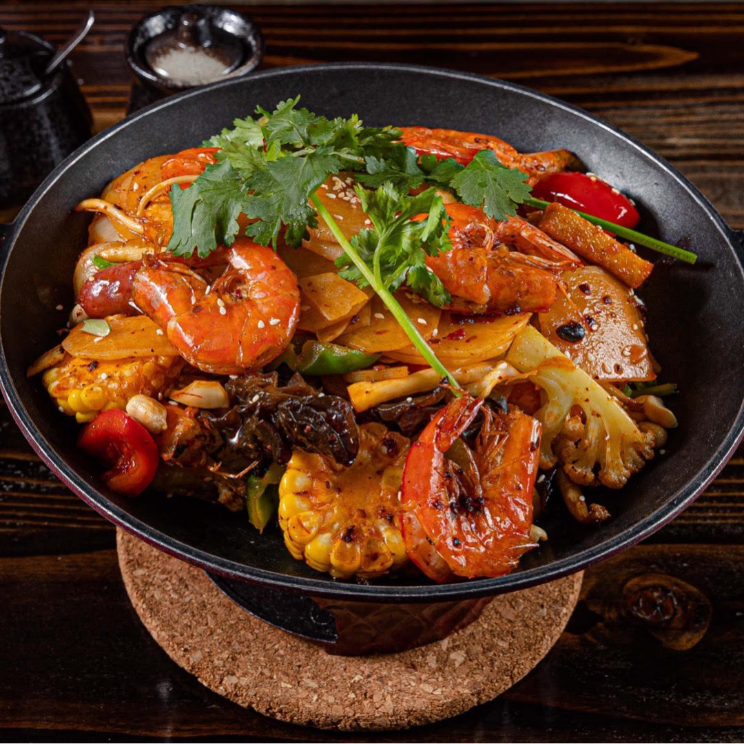 Spicy shrimp dry pot mixed with fresh vegetables and seasonings at Dun Huang, a Chinese Restaurant in Brooklyn
