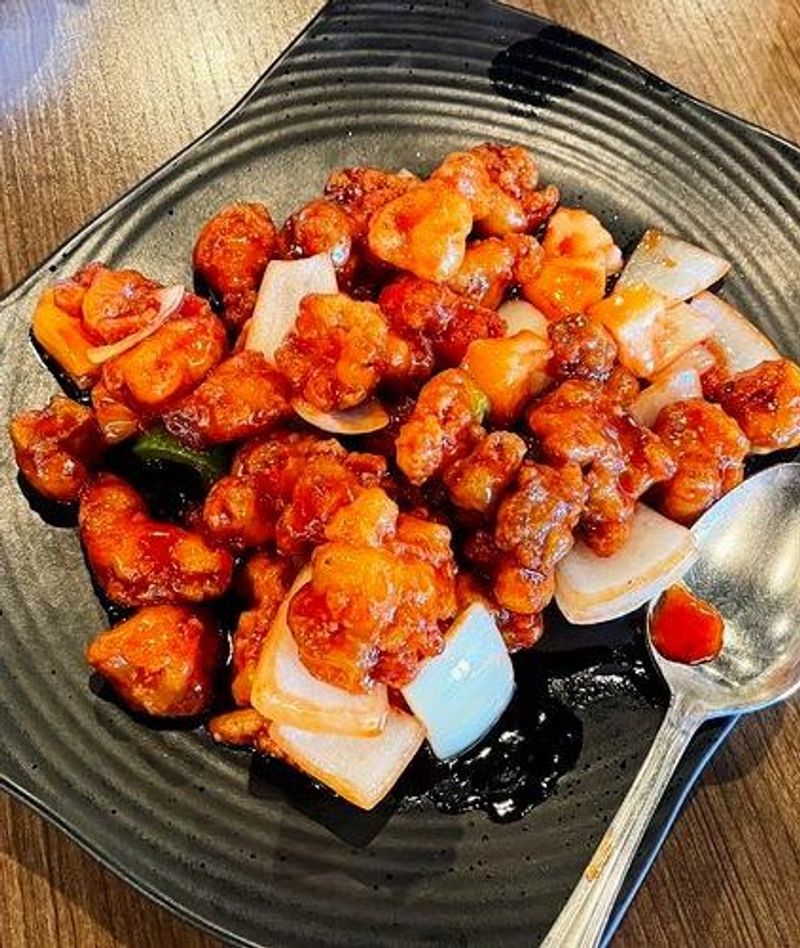 Sweet and sour crispy chicken chunks with onion and bell pepper stir-fry at Canaan Chinese Cuisine, a Chinese Restaurant in CA Sweet and sour crispy chicken chunks with onion and bell pepper stir-fry at Canaan Chinese Cuisine, a Chinese Restaurant in CA