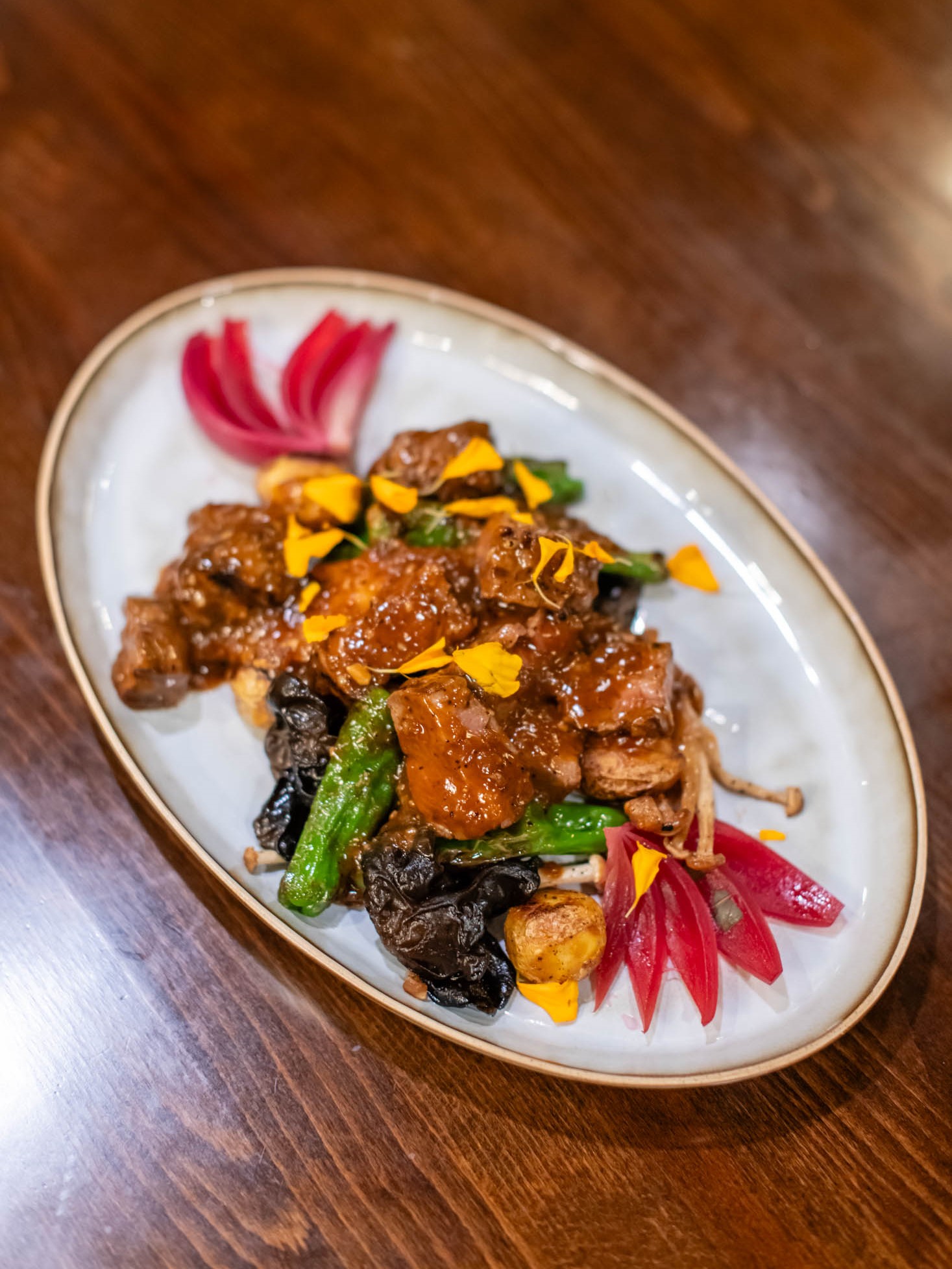 Glazed beef cubes stir-fried with wood ear mushrooms and decorative pickled radish at Canaan Chinese Cuisine, a Chinese Restaurant in CA