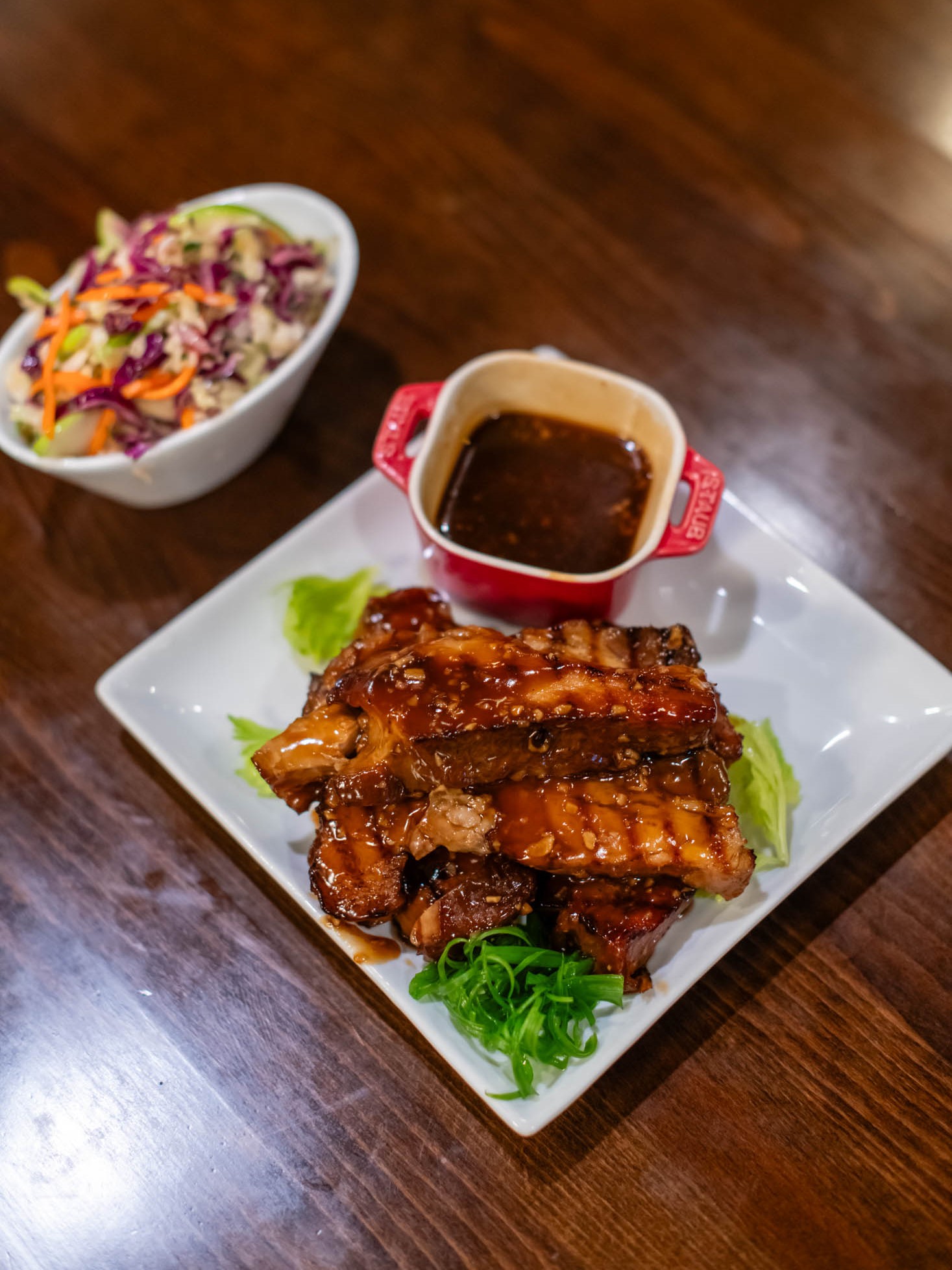 Glazed barbecue pork ribs served with coleslaw and tangy dipping sauce at Canaan Chinese Cuisine, a Chinese Restaurant in CA