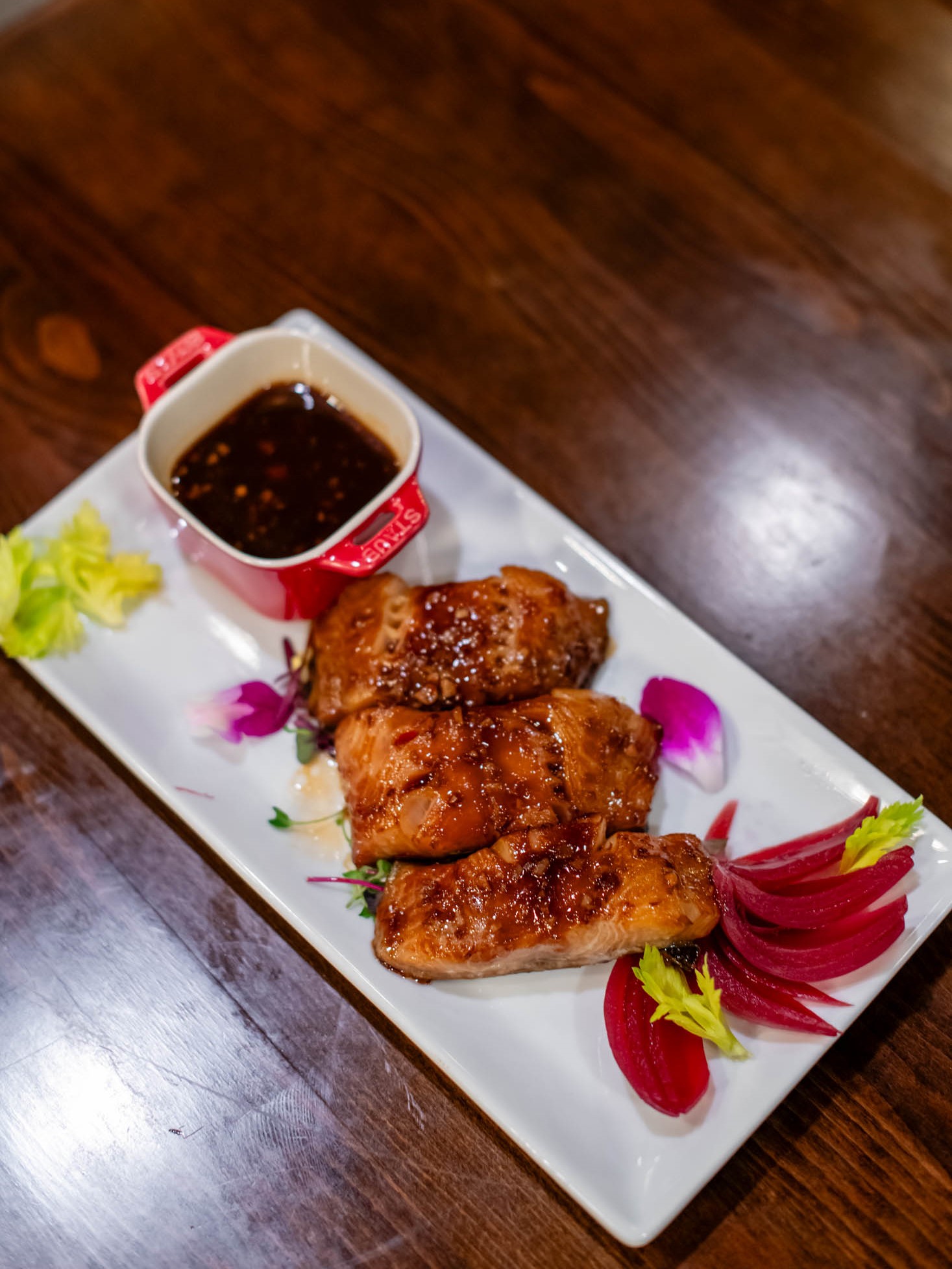 Glazed grilled salmon fillets served with dark savory dipping sauce and pickled radish at Canaan Chinese Cuisine, a Chinese Restaurant in CA
