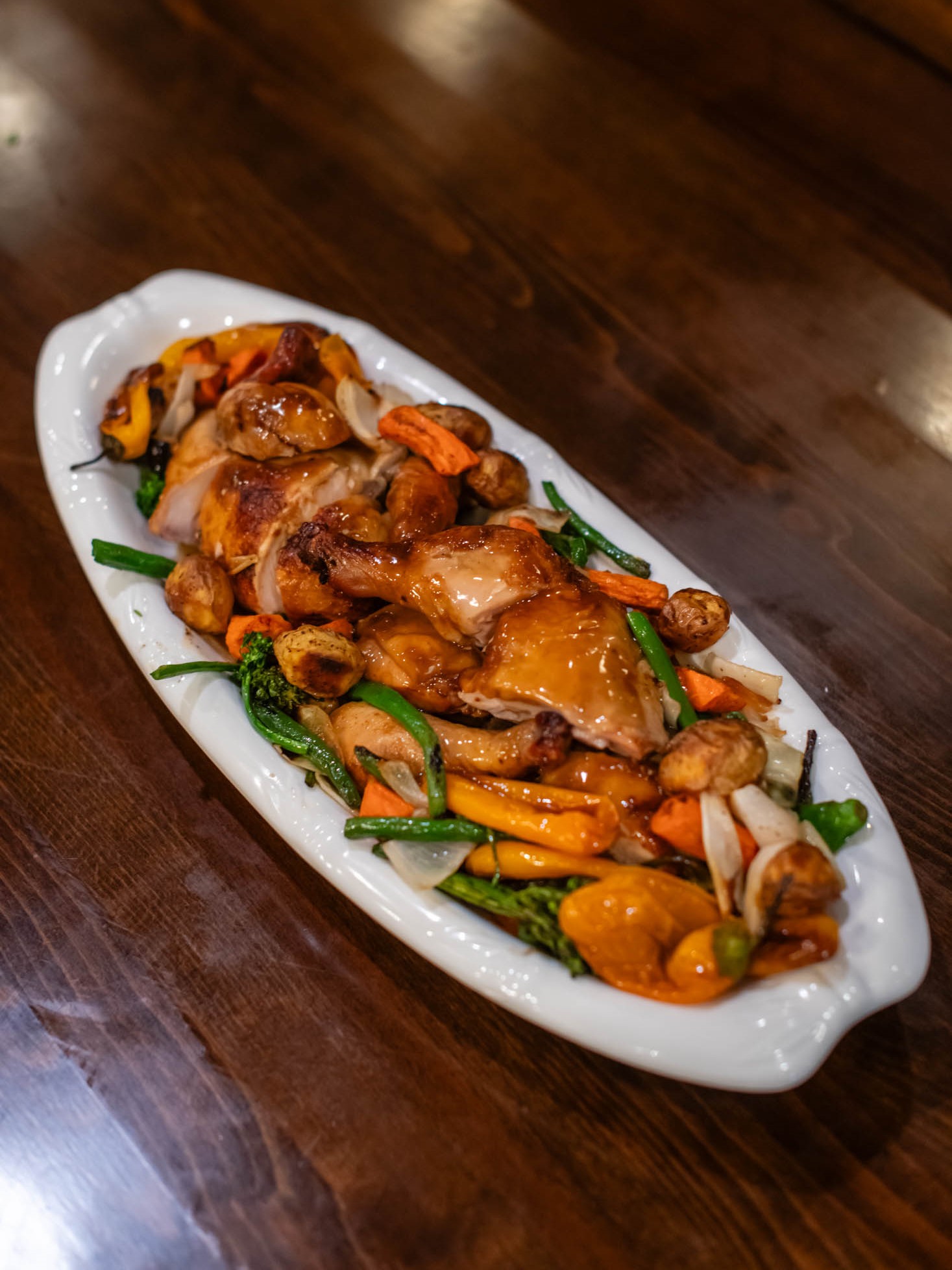 Glazed roasted chicken platter mixed with colorful roasted seasonal vegetables at Canaan Chinese Cuisine, a Chinese Restaurant in C