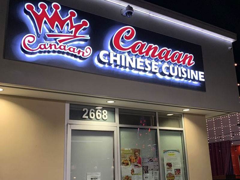 Illuminated 3D crown logo sign for Canaan Chinese Cuisine above entrance at night at Canaan Chinese Cuisine, a Chinese Restaurant in West Covina
