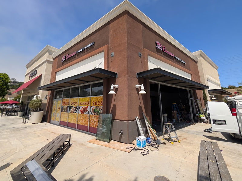 Restaurant building undergoing construction with Coming Soon window decals on sunny day at Canaan Chinese Cuisine, a Chinese Restaurant in West Covina