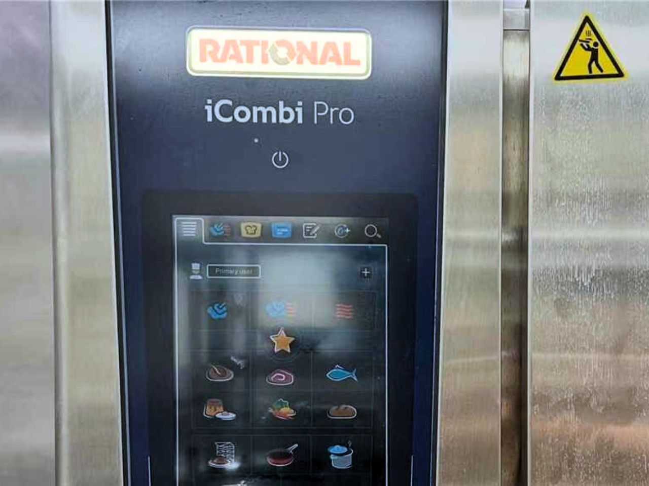 Control panel of the Rational iCombi Pro oven with various icons at EatGrand, a Japanese Restaurant in Los Angeles