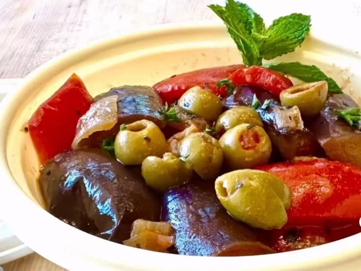 Eggplant with olives and red peppers in savory sauce at EatGrand, a Japanese Restaurant in Los Angeles