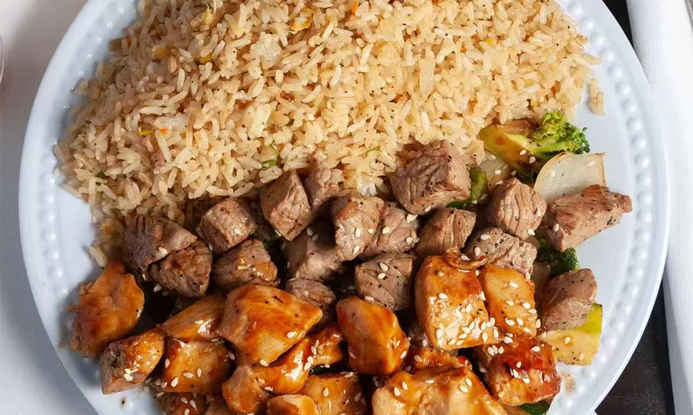 Mixed chicken and beef cubes with seasoned fried rice and veggies at Nihao, a Chinese Restaurant in Lexington