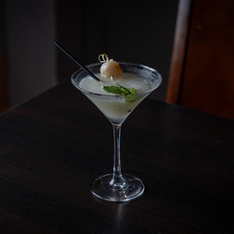 A cocktail on a black table.