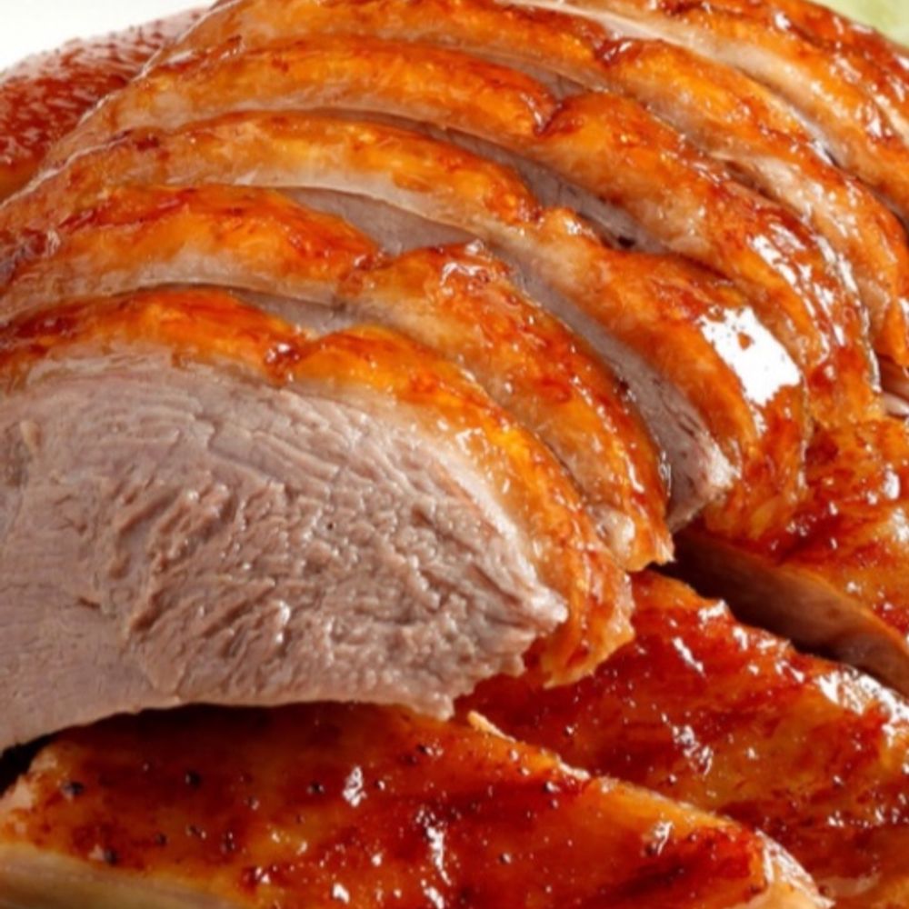 Sliced roasted duck with crispy glazed skin