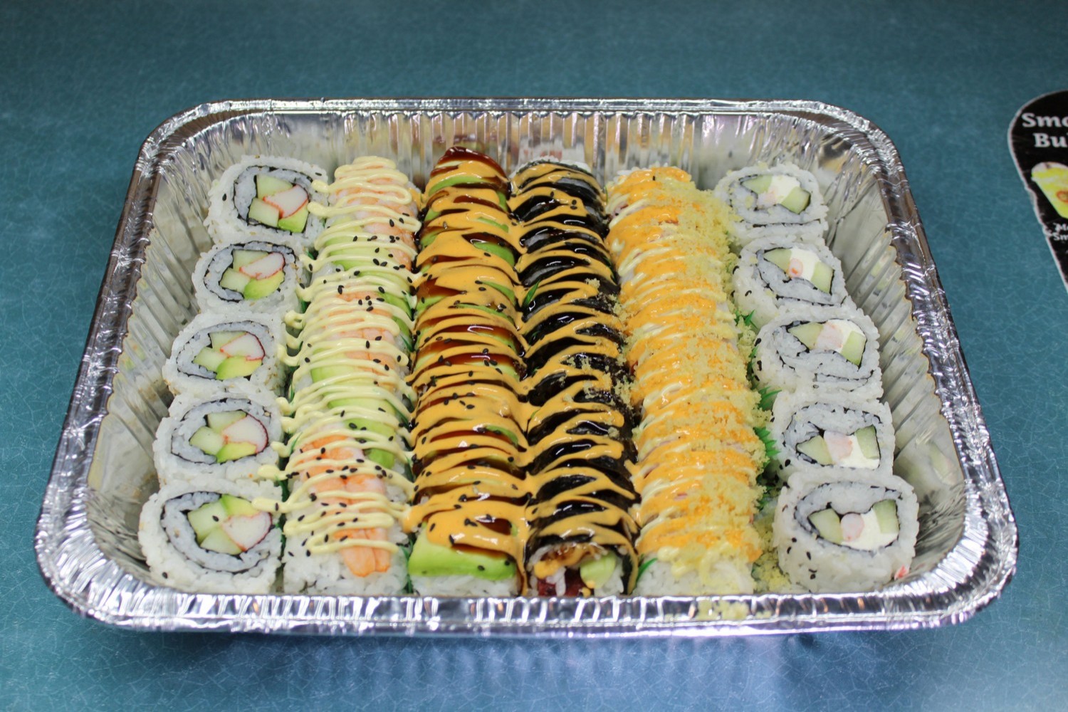 Assorted sushi rolls with various sauces and fillings at Elgin Buffet, a Buffet Restaurant in Elgin