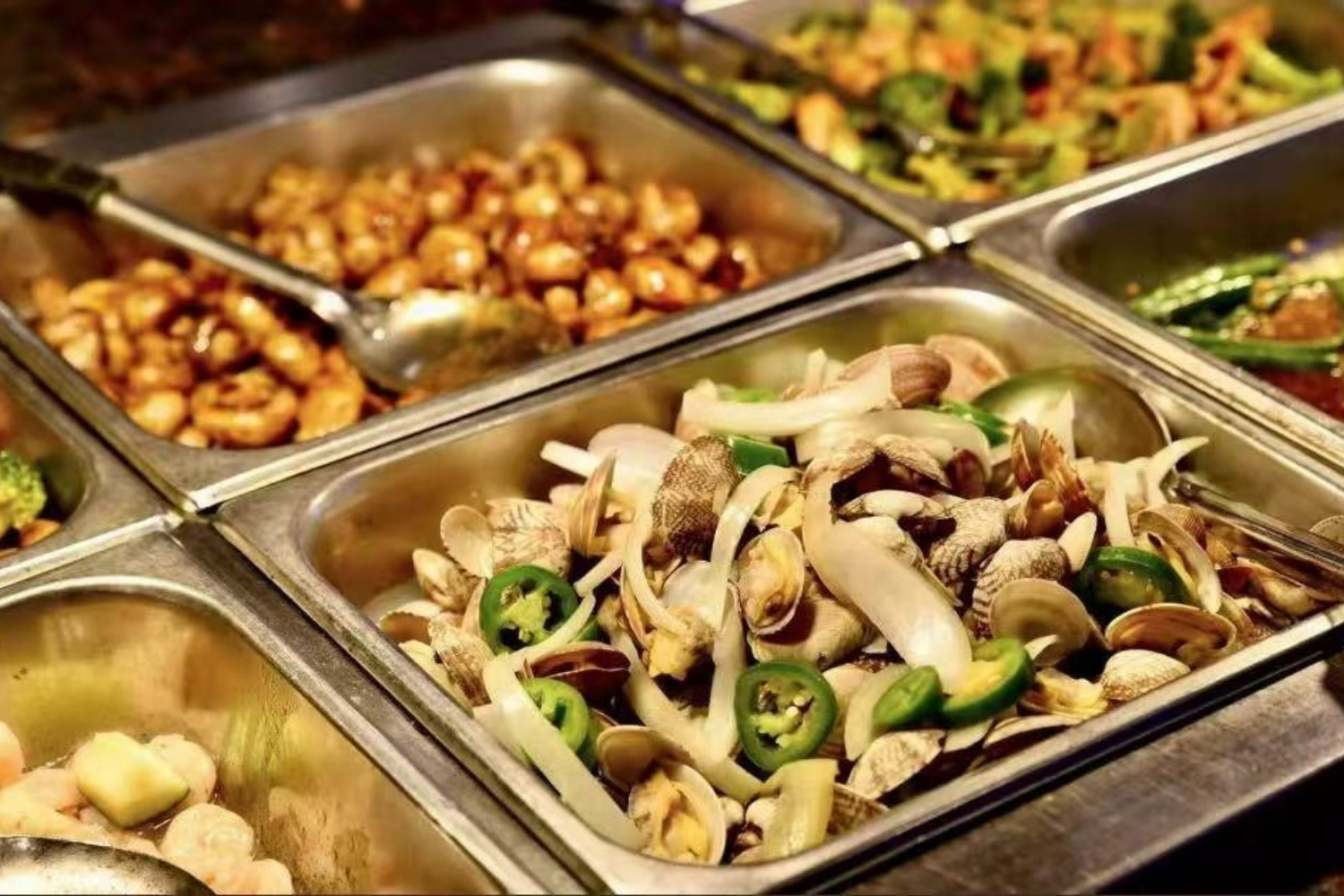 Metal buffet trays filled with clams, shrimp and stir-fried seafood at Elgin Buffet, a Buffet Restaurant in Elgin