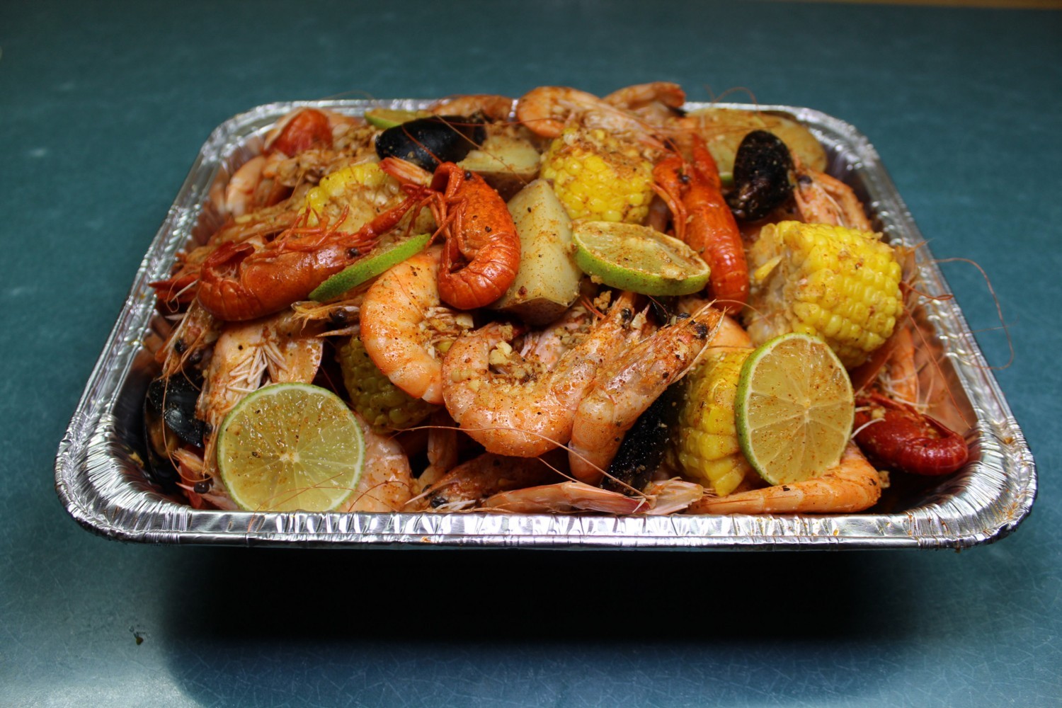 Seafood boil platter with shrimp corn potato lime slices at Elgin Buffet, a Buffet Restaurant in Elgin
