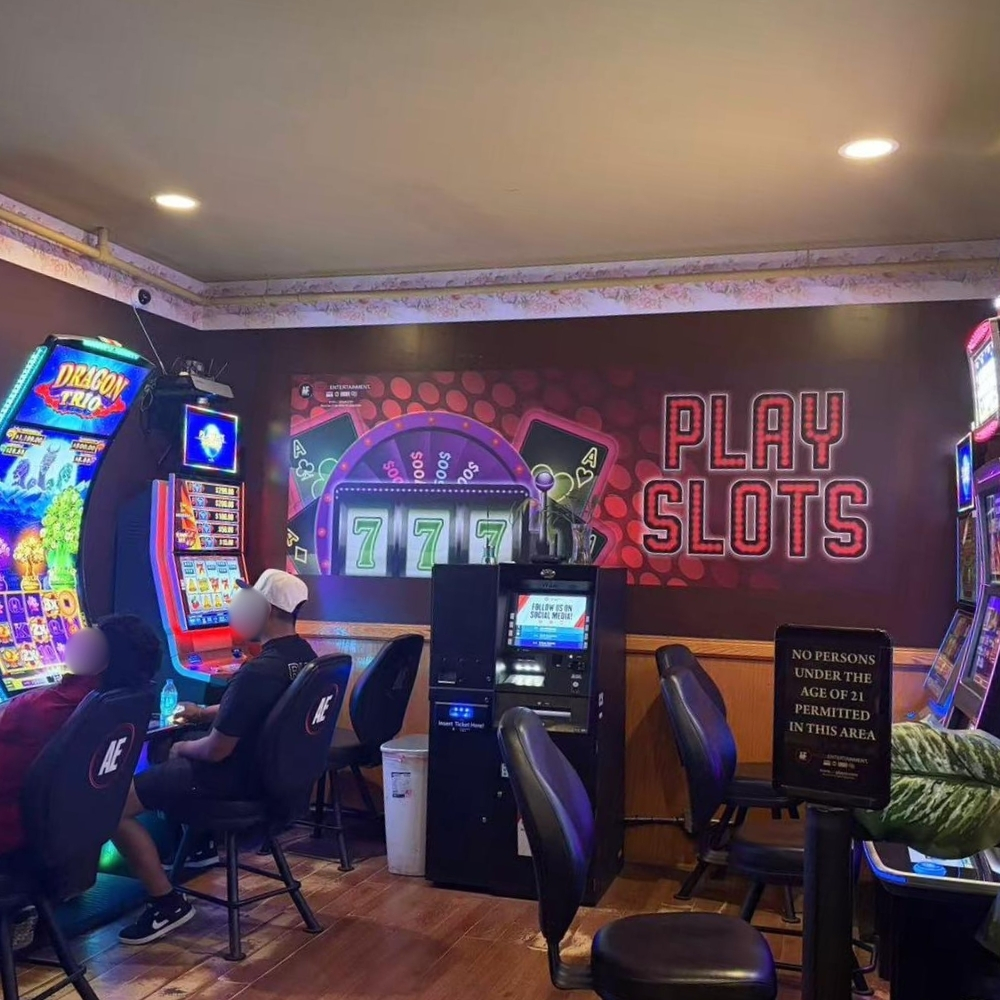 Slot machine gaming zone with PLAY SLOTS neon wall decor at Elgin Buffet, a Buffet Restaurant in Elgin