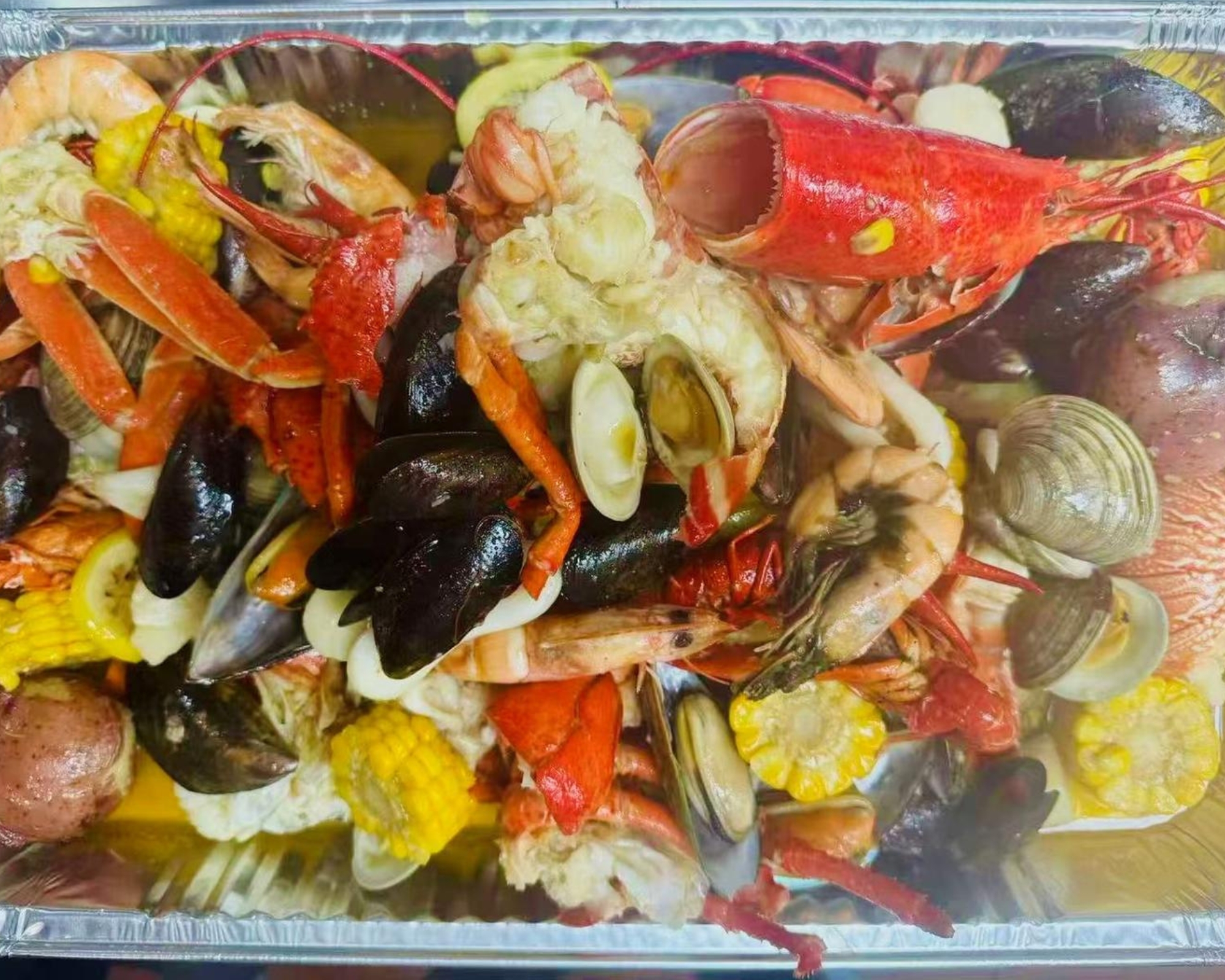 Empire-Wings-Chicken-Wings-Restaurant-Seafood-Boil-Brooklyn Assorted seafood boil with corn and potatoes at Empire Wings, a Chicken Wings Restaurant in Brooklyn