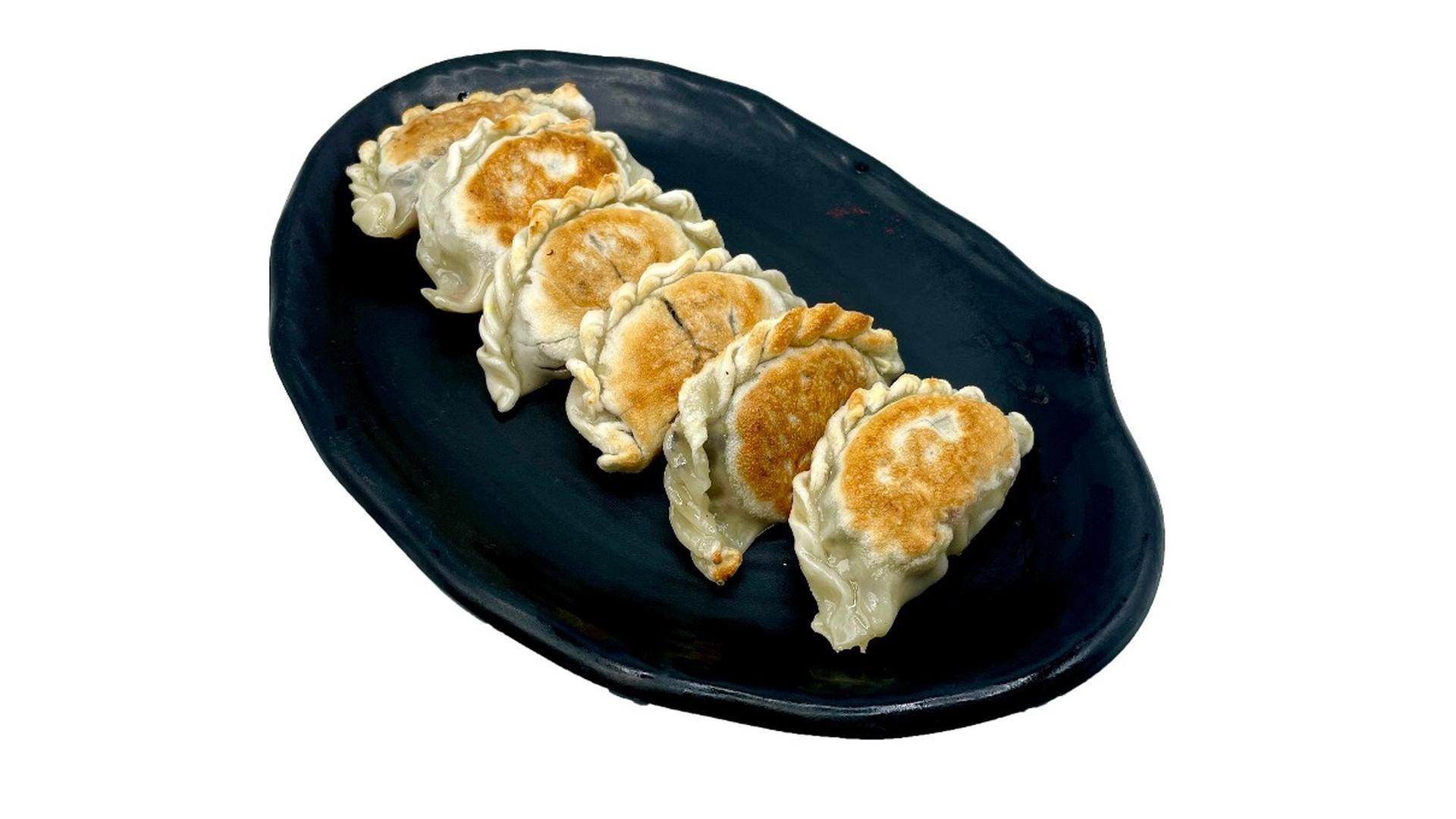 Pan‑fried dumplings with crimped edges at E Noodle, a Chinese Restaurant in Brooklyn