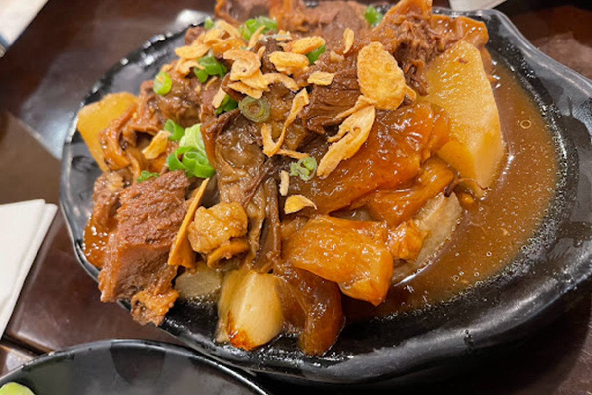 Braised beef brisket stew with tender radish, fried garlic and green onions at E Noodle Chinatown, a Chinese Restaurant in New York