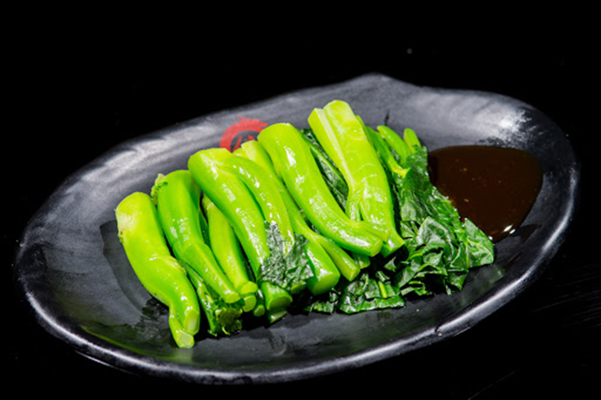 Blanched fresh choy sum with thick brown savory dipping sauce at E Noodle Chinatown, a Chinese Restaurant in New York
