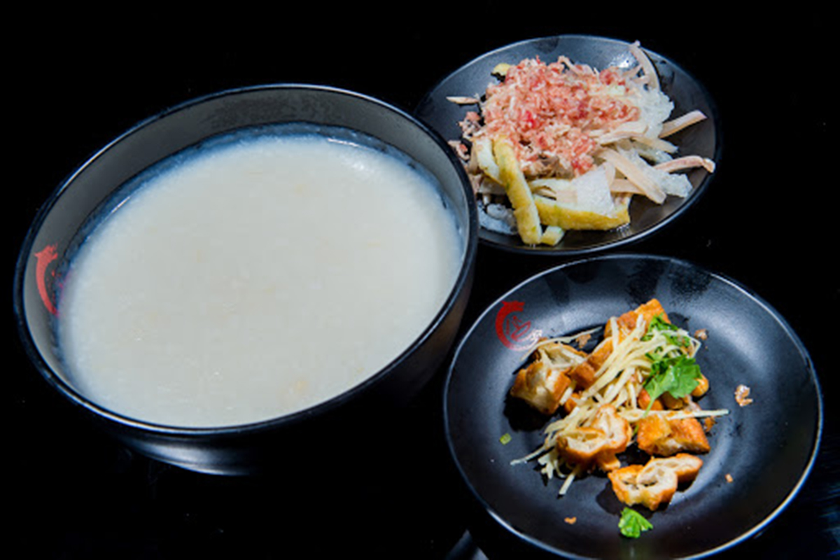 Plain congee set with two side plates of shredded meat and fried dough sticks at E Noodle Chinatown, a Chinese Restaurant in New York