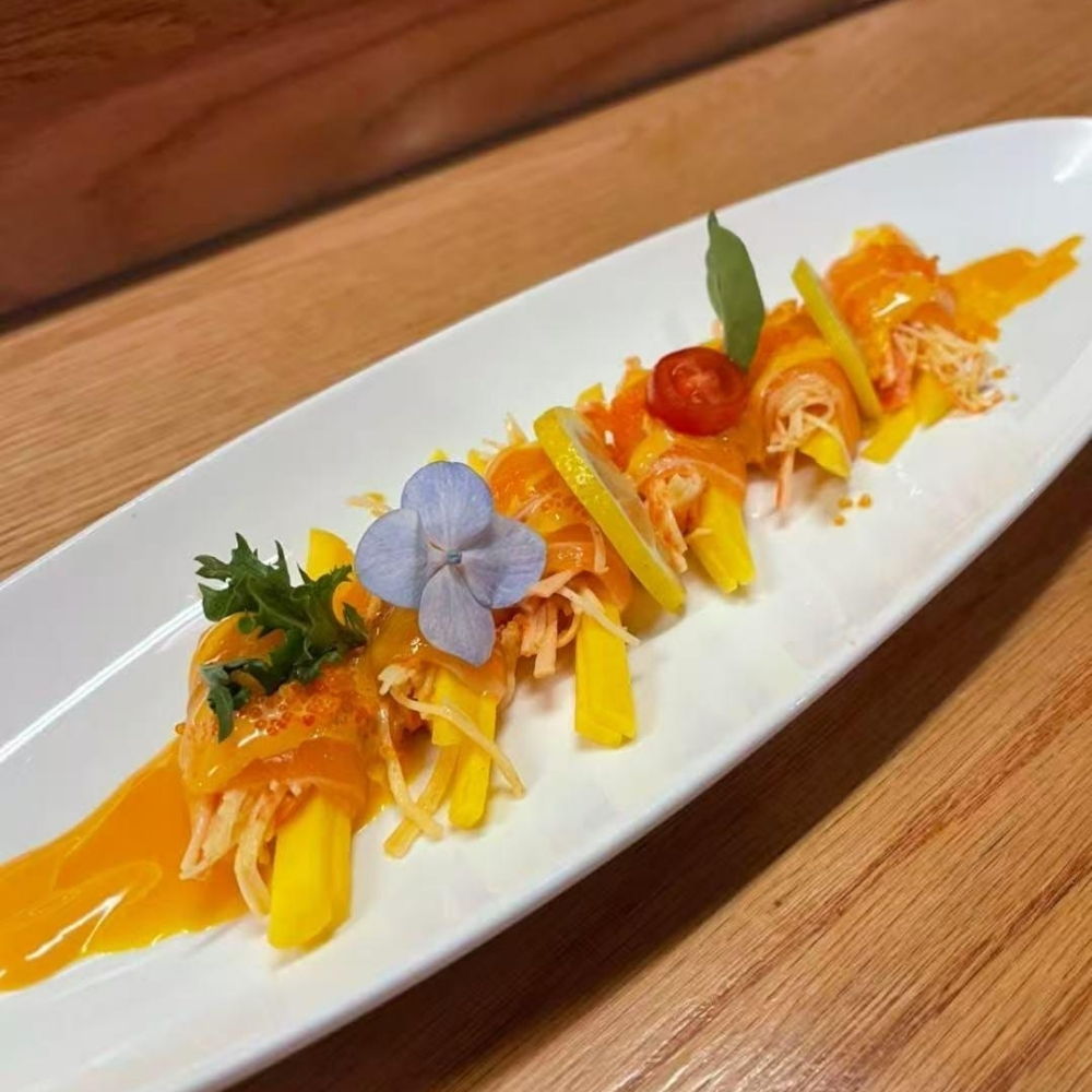 Mango-wrapped sushi with sauce at Raku Sushi, a Japanese Restaurant in Easton
