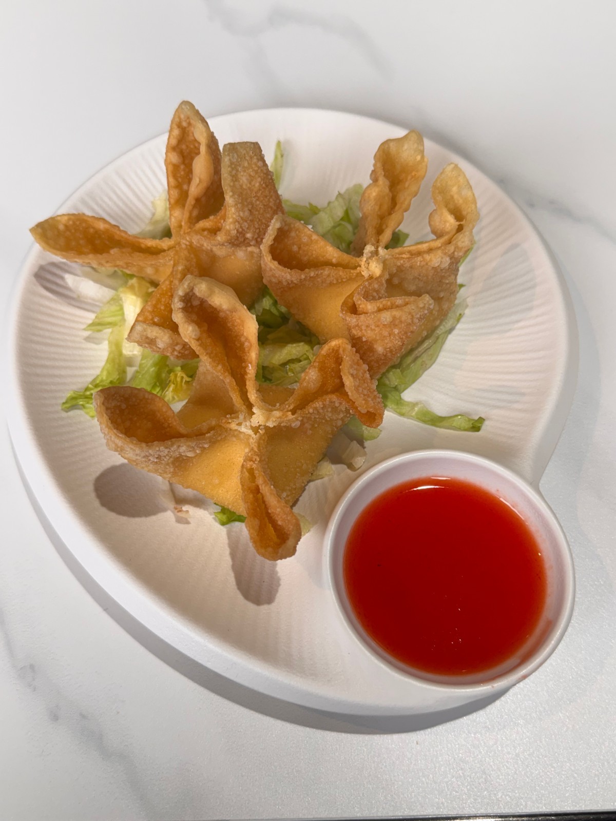 Crispy fried wontons with sweet chili dipping sauce at Takumi, a Japanese Restaurant in Fairview Heights