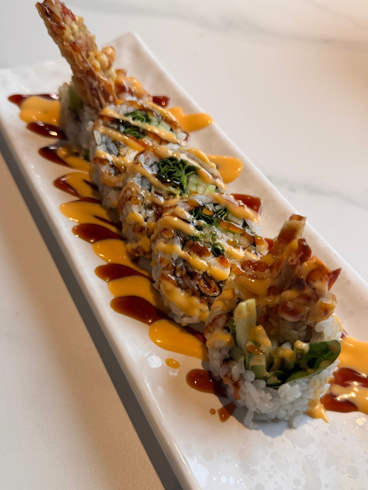 Tempura shrimp sushi roll with spicy mayo, eel sauce at Takumi, a Japanese Restaurant in Fairview Heights