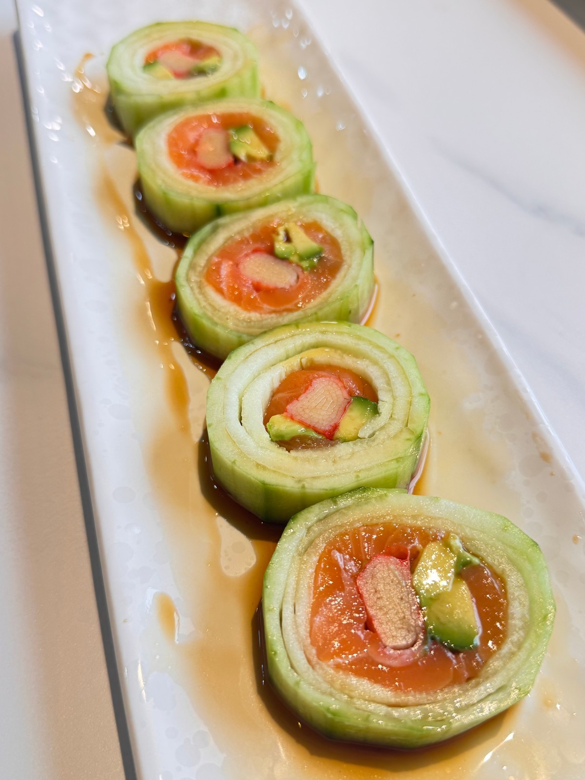 Thin cucumber-wrapped salmon sushi roll at Takumi, a Japanese Restaurant in Fairview Heights