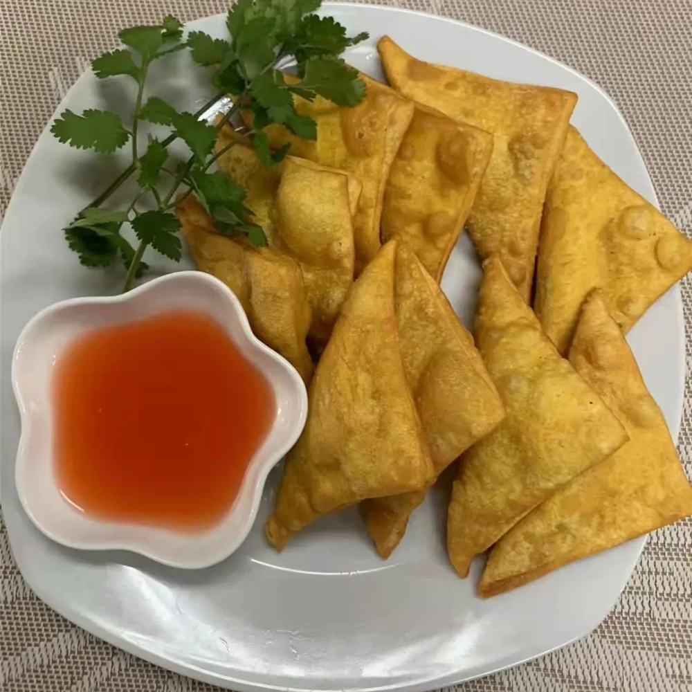 Fried samosas with dipping sauce at Family Kitchen, an Chinese Restaurant in Brooklyn.
