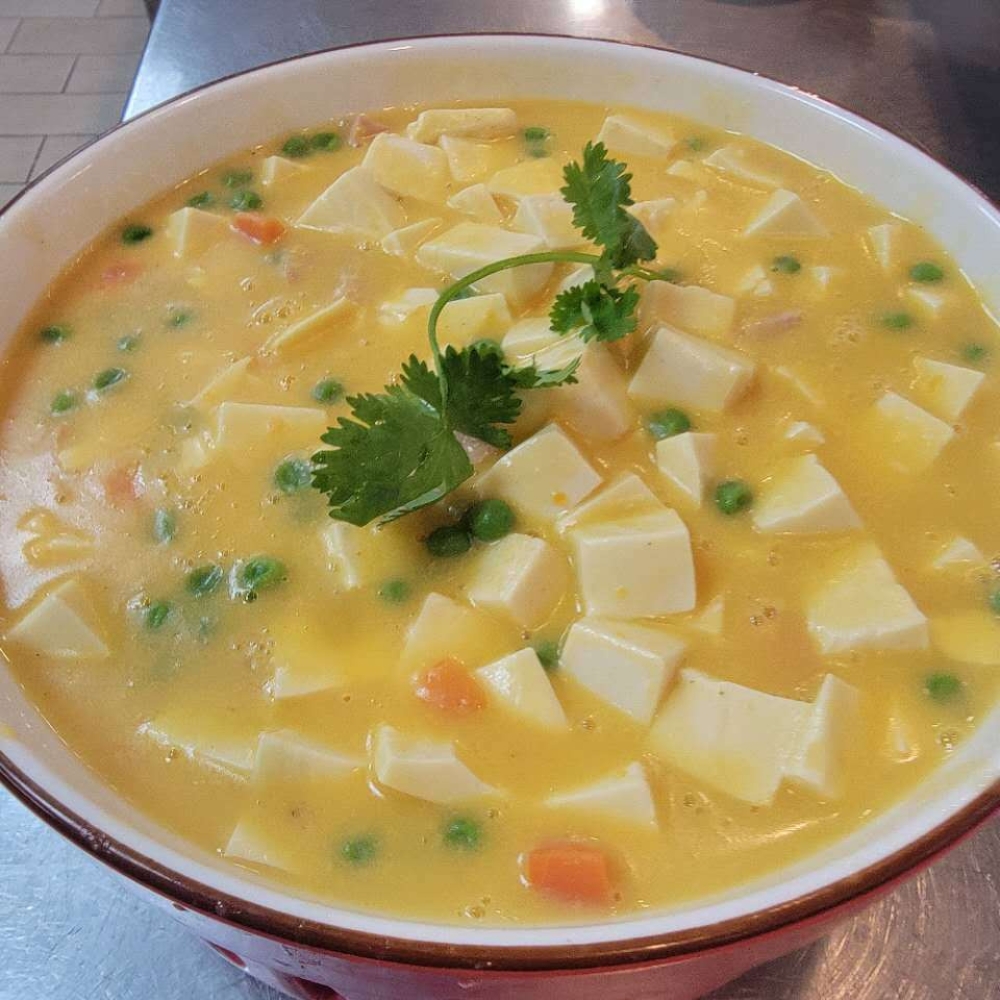 Creamy tofu soup with peas, carrots and cilantro at Farmer kitchen, a Chinese Restaurant in Monterey Park