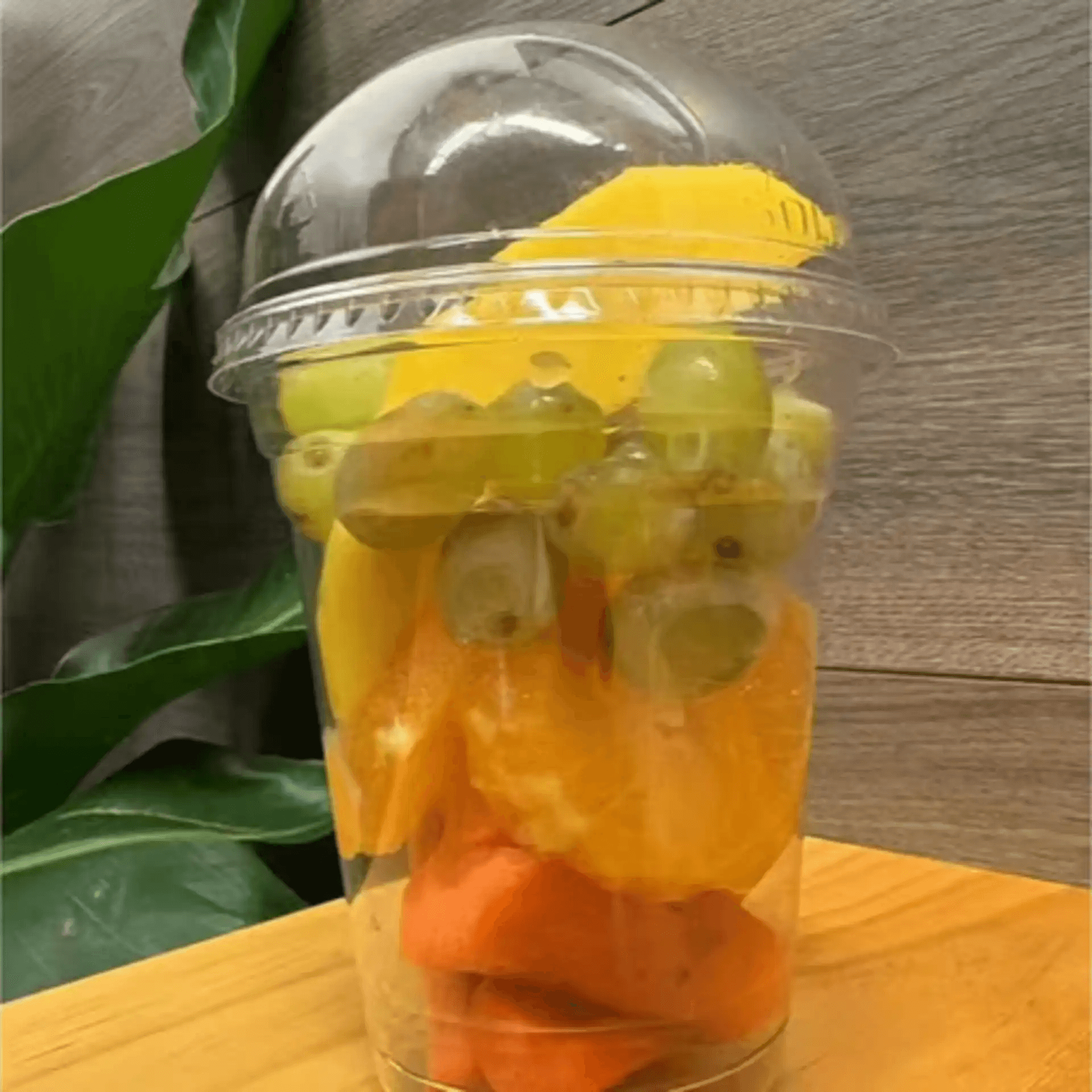 Cup with mango, grapes, orange slices and carrots at F-F IN BOWL, a Asian Fusion Restaurant in Santa Rosa
