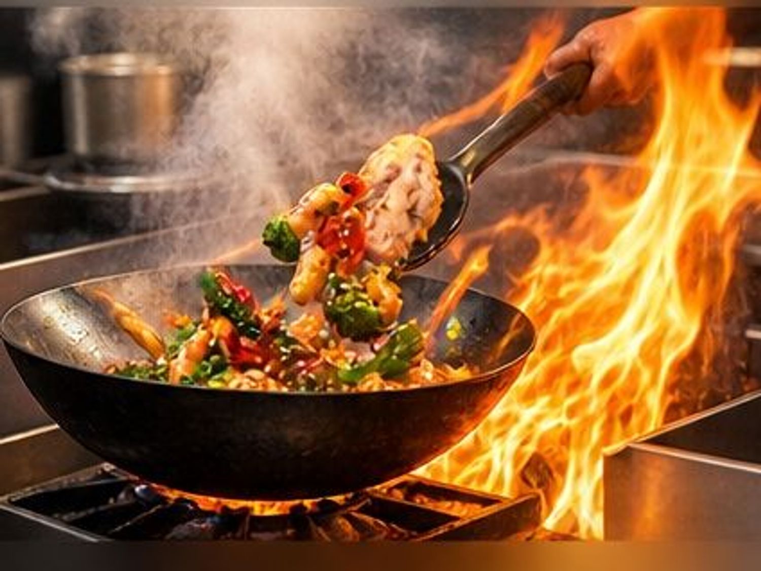 Wok stir‑frying meat and vegetables over high open flame in restaurant kitchen