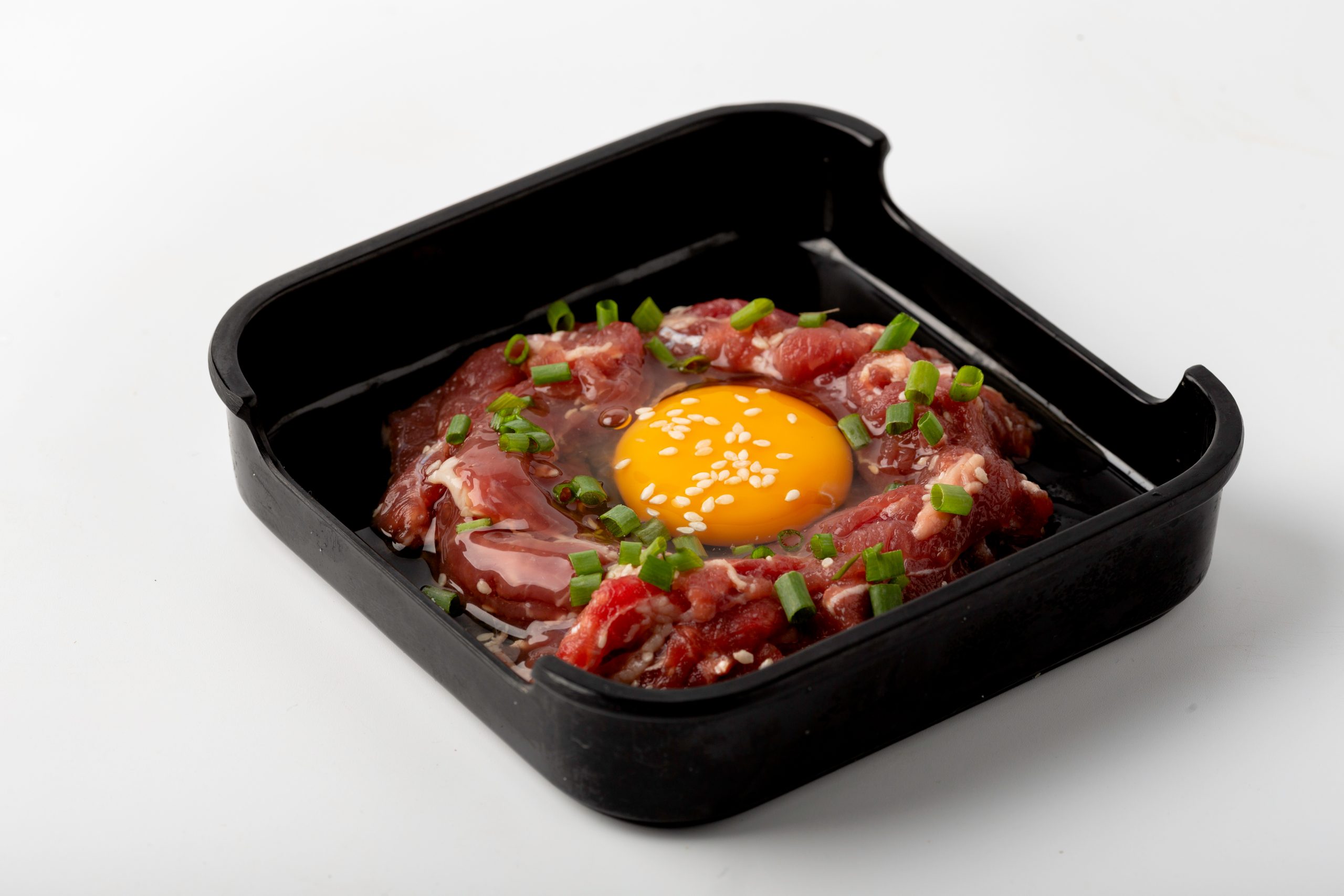 Raw beef seasoned with green onions and an egg yolk at Firestone Hotpot & BBQ Restaurant in Tallahassee