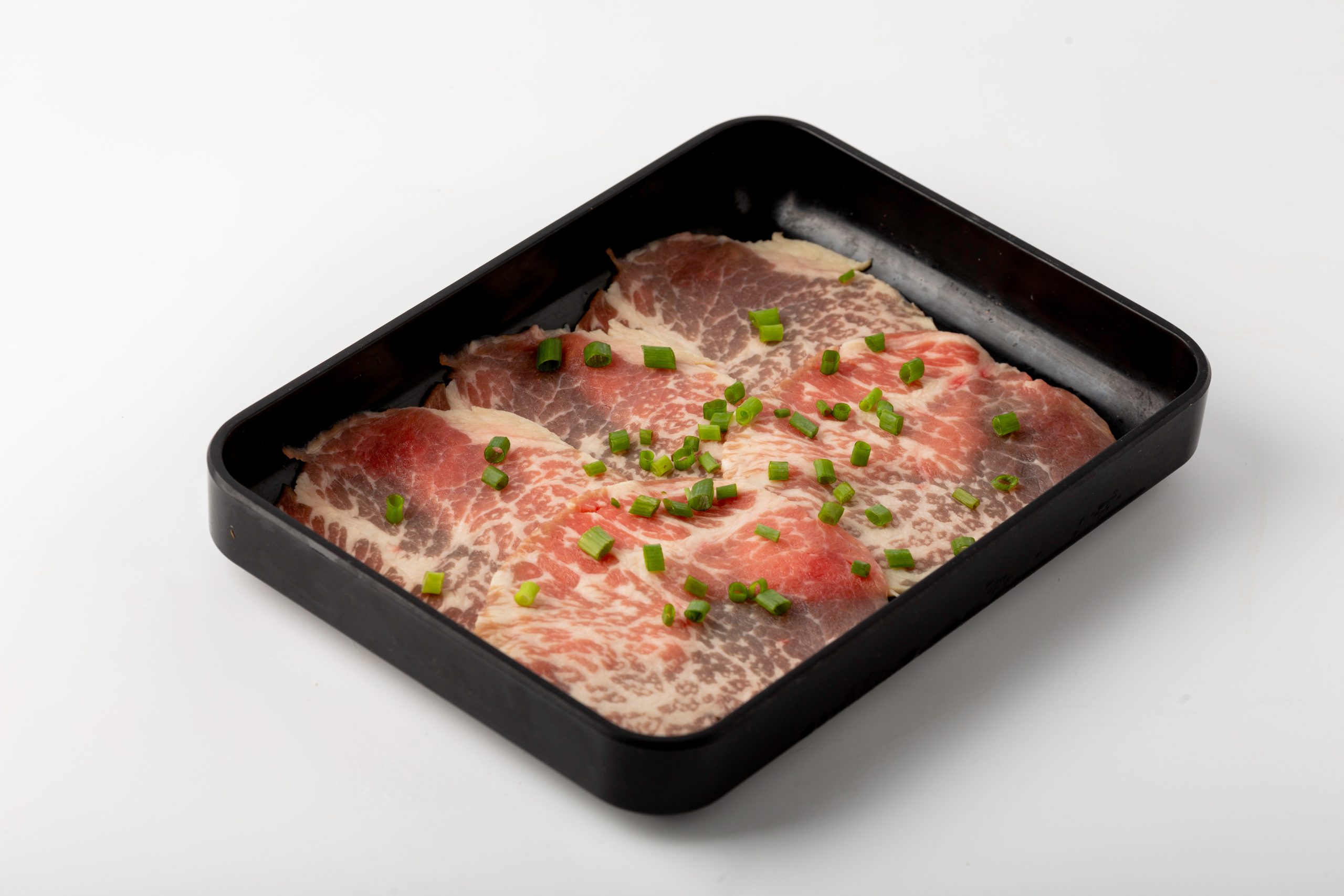 Thin beef slices with chopped green onions at Firestone Hotpot & BBQ Restaurant in Tallahassee