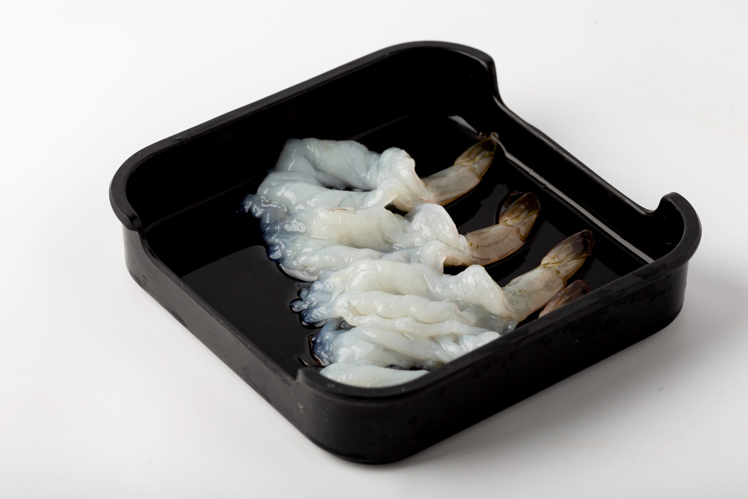 Fresh raw peeled shrimps in a black container at Firestone Hotpot & BBQ Restaurant in Tallahassee