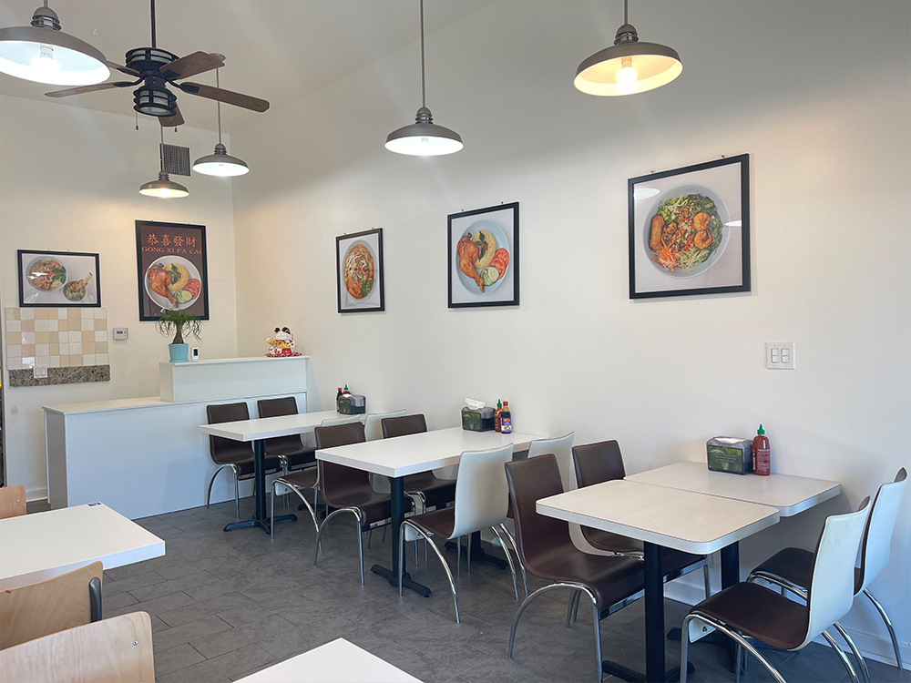 Bright Fivefive Noodles restaurant interior with tables, chairs, and wall art