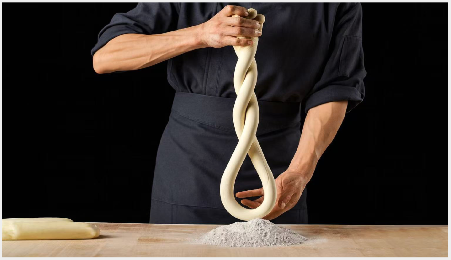 Chef twists dough into shape at First Meeting Noodle, a Chinese Restaurant in Rochester