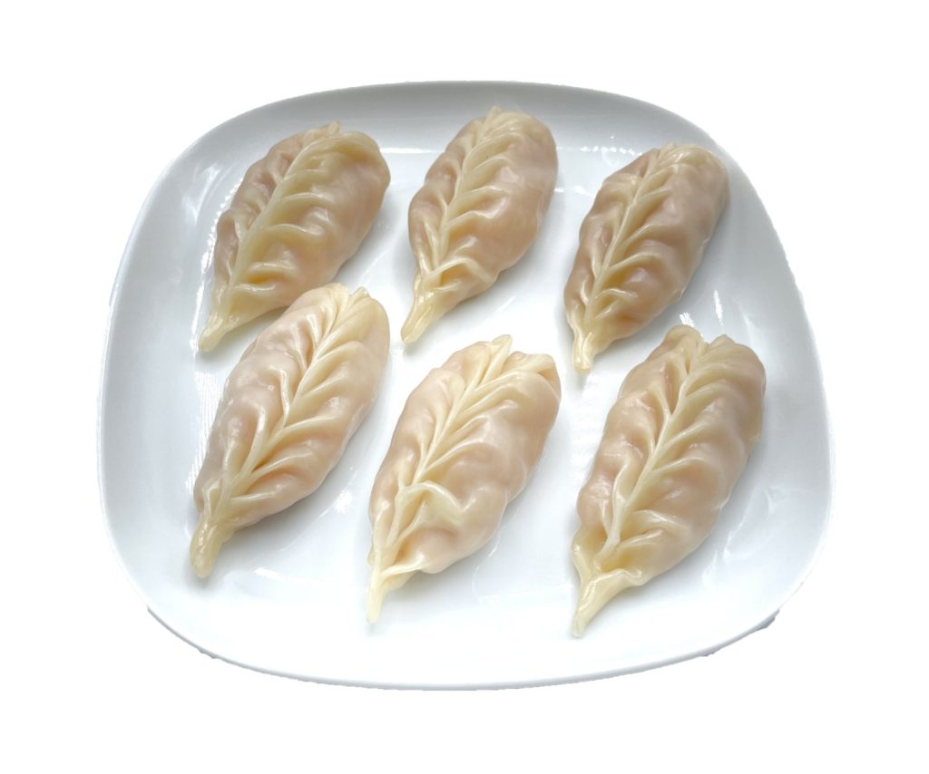 Leaf-shaped steamed dumplings on white plate at Fok Noodles Express, an Asian Restaurant in New York.