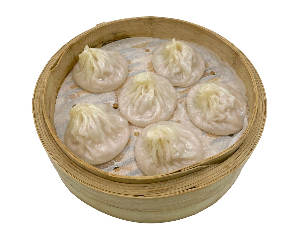 Steamed pork soup dumplings in bamboo steamer at Fok Noodles Express, an Asian Restaurant in New York.