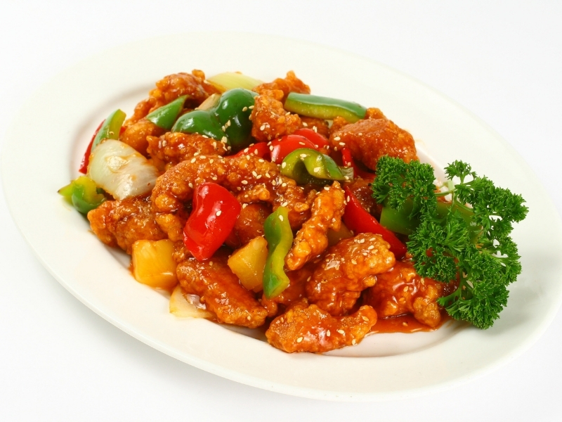 Crispy sesame chicken with bell peppers and sesame seeds at Foodieholic Chinese Noodle & Kitchen, a Chinese restaurant in Durham