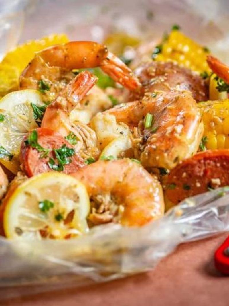 Cajun seafood boil with shrimp, corn, sausage, lemon and fresh herbs