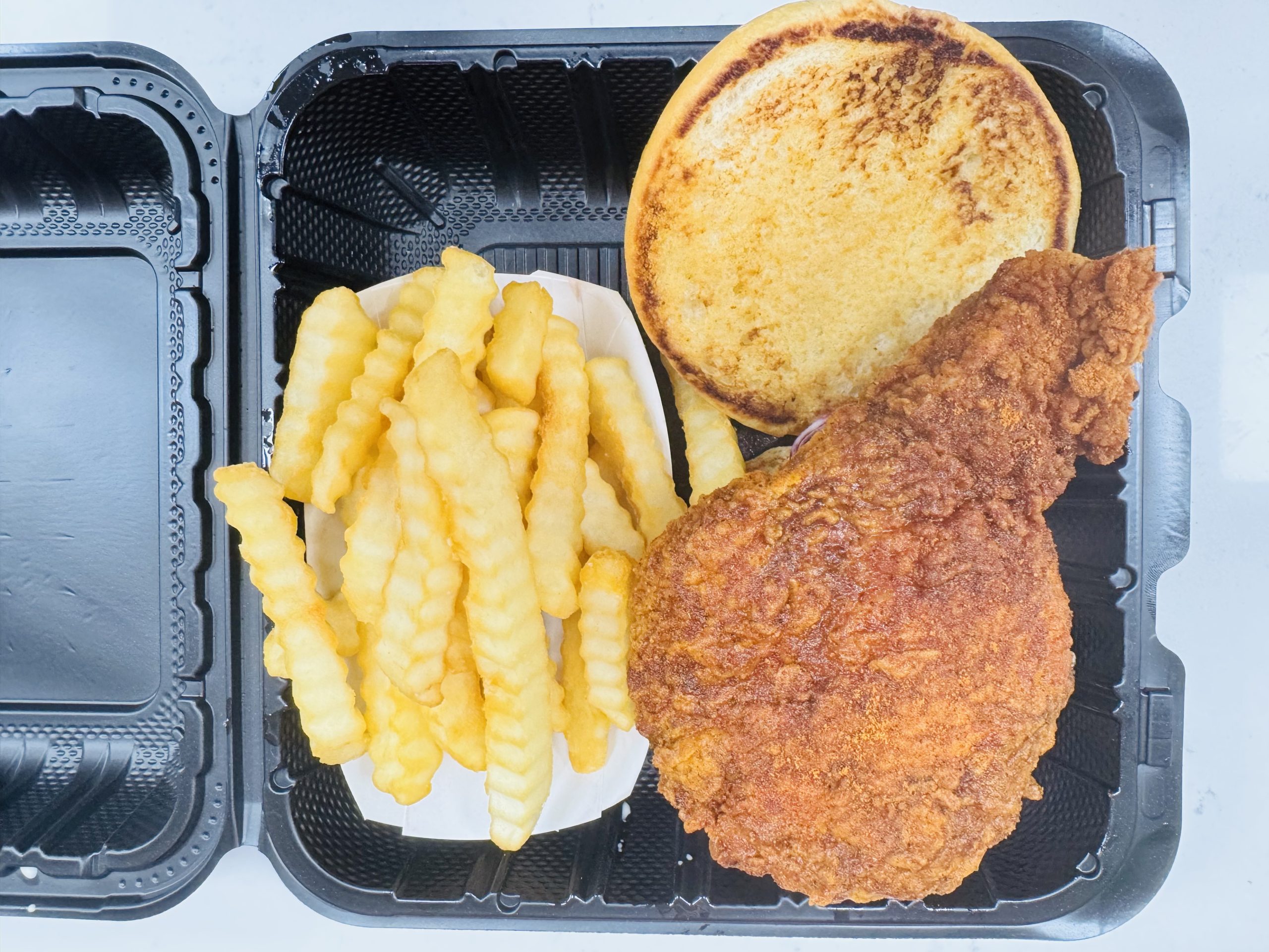 Fried chicken meal with fries and bun at Frank’s Hot Chicken, a Fast - Food Restaurant in Jonesboro
