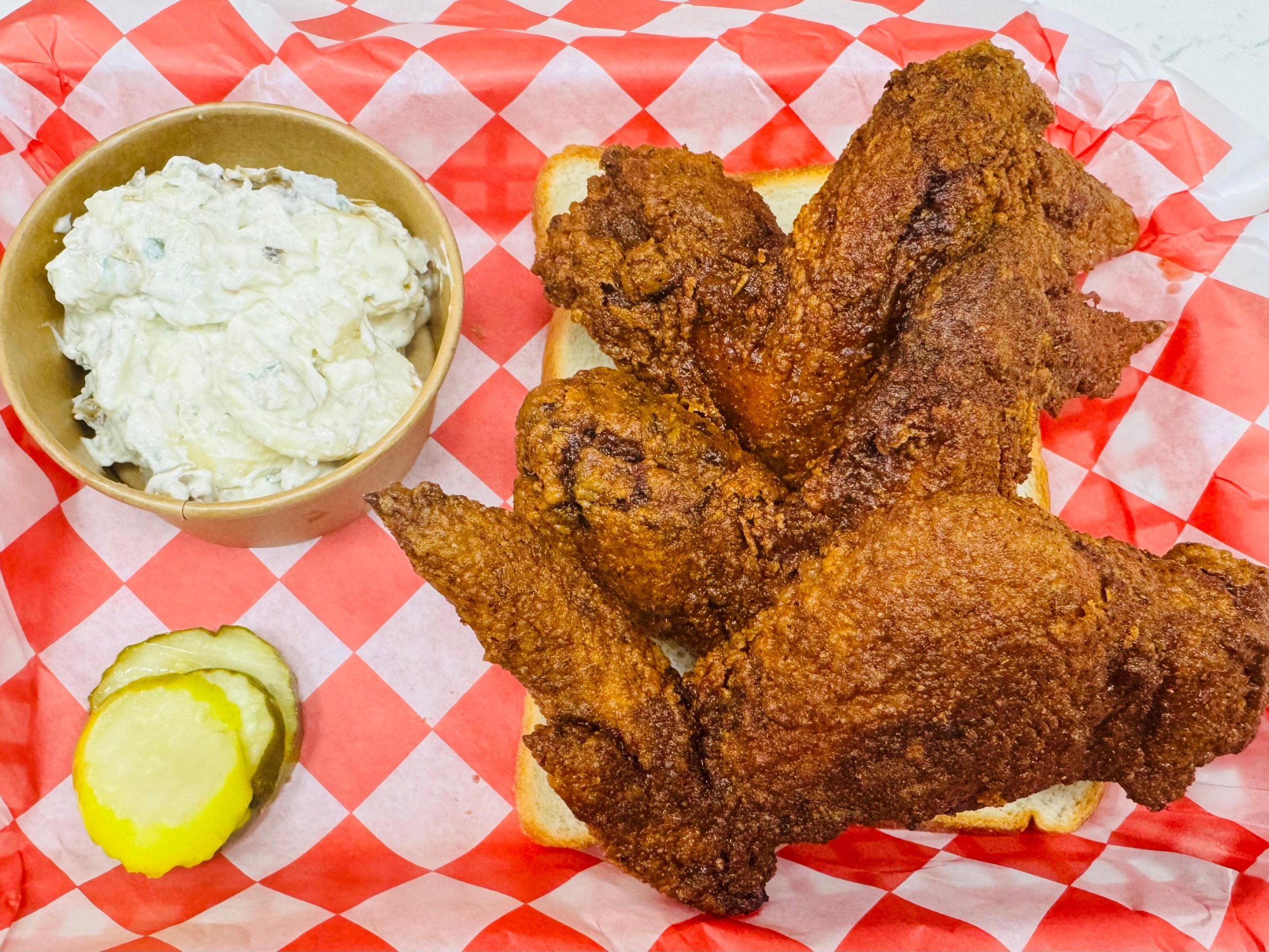 Fried chicken wings with potato salad at Frank’s Hot Chicken, a Fast - Food Restaurant in Jonesboro