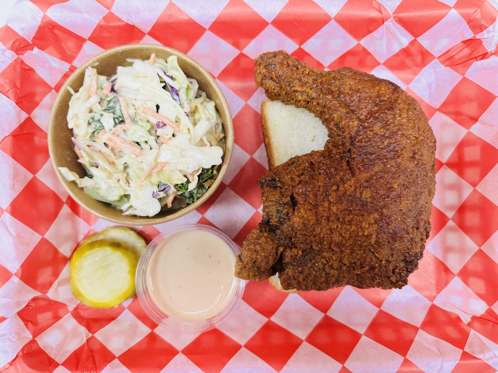 Fried chicken with coleslaw and pickle at Frank’s Hot Chicken, a Fast - Food Restaurant in Jonesboro
