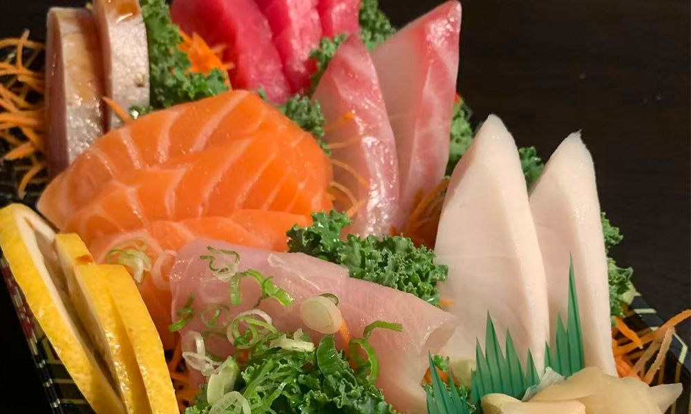 Fuji-Hibachi&Sushi-Japanese-Restaurant-Assorted-Sashimi-Platter-Monroe Fresh assorted sashimi with lemon, garnished veggies. Aburi Salmon Sushi Roll at Fuji Hibachi&Sushi in Monroe
