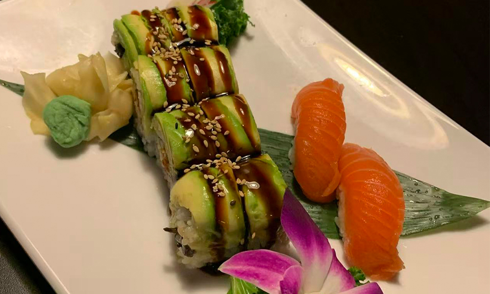 Avocado sushi roll served with salmon nigiri, wasabi, and ginger. Aburi Salmon Sushi Roll at Fuji Hibachi&Sushi in Monroe