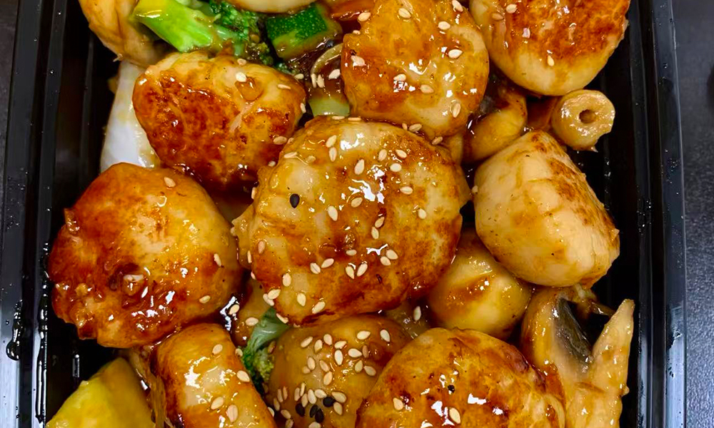 Scallops in teriyaki sauce with sesame seeds and veggies. Aburi Salmon Sushi Roll at Fuji Hibachi&Sushi in Monroe