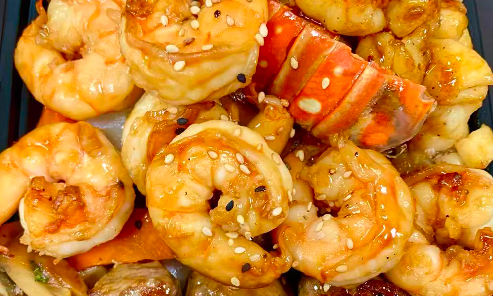 Shrimp in teriyaki sauce with sesame seeds and lobster piece. Aburi Salmon Sushi Roll at Fuji Hibachi&Sushi in Monroe