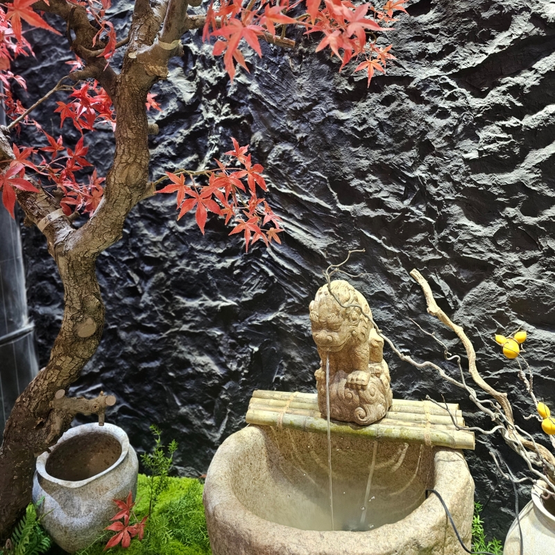 A stone fountain with a lion statue at Fujisan, a Japanized Western Restaurant in Chandler