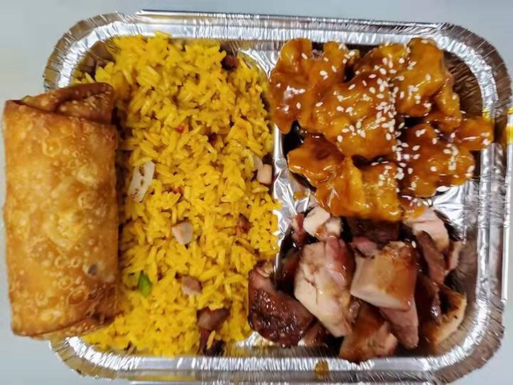 Combination platter with fried rice, chicken, pork and spring roll