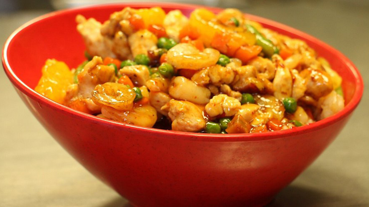 Mongolian & Sushi-Asian-Fusion-Restaurant-Chicken-and-Shrimp-Carteret Chicken, shrimp and mixed vegetables like peas and carrots in a red bowl, appetizing in color at Mongolian & Sushi,a Asian Fusion Restaurant in Carteret