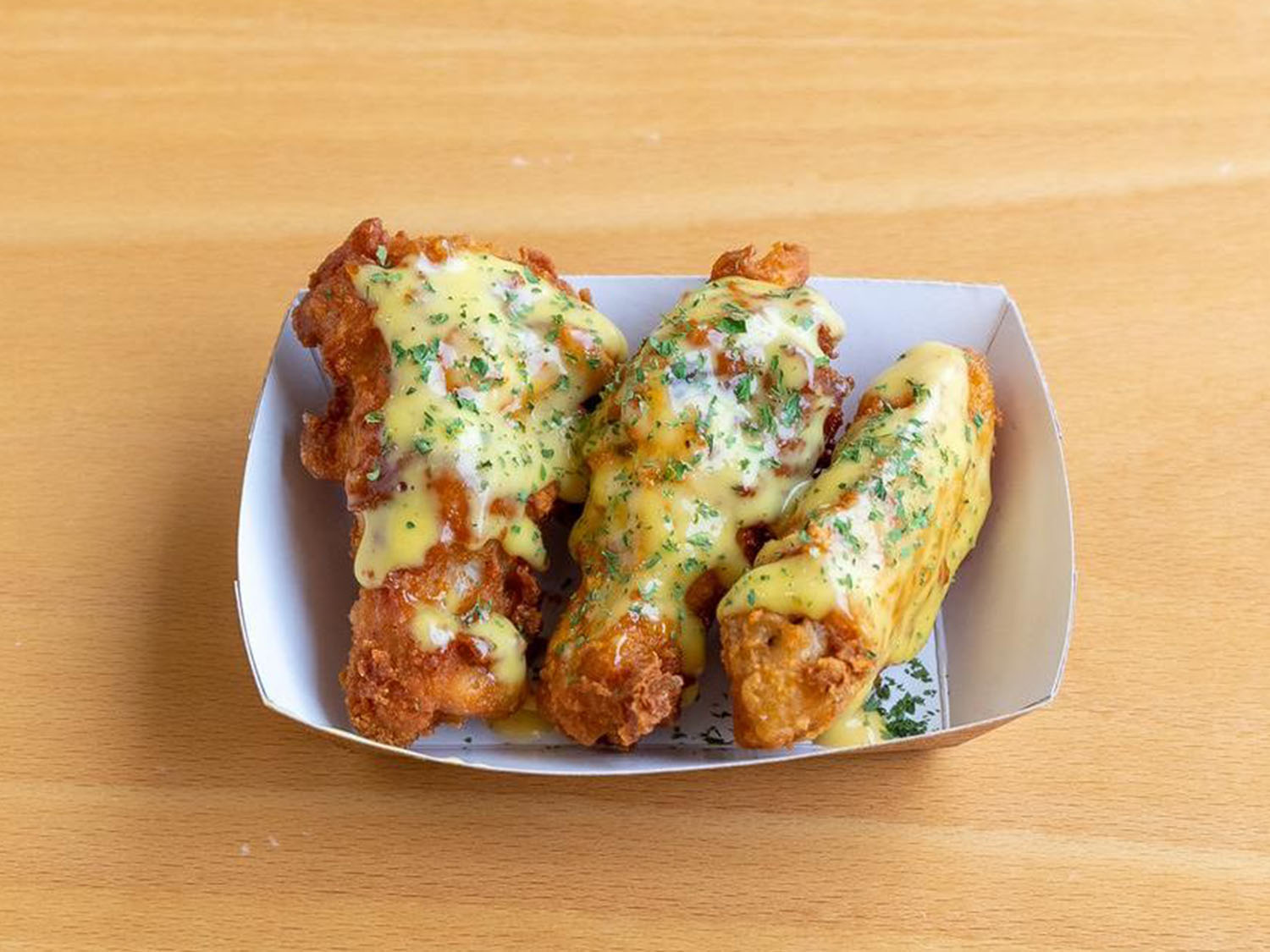 Cheesy garlic chicken wings with herbs at Fusion Poke, an Asian Fusion Restaurant in Milwaukee